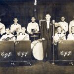 Harvery Devigne is the person in the left rear holding the trumpet Harvey_Devigne_left