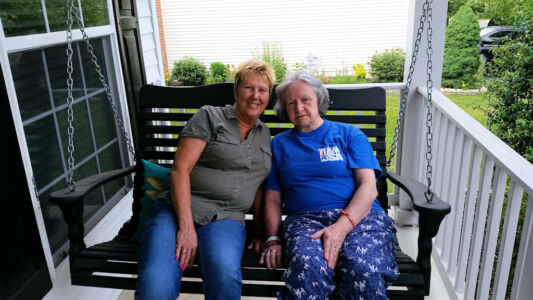 Granny & Caretaker Brenda on the front porch swing